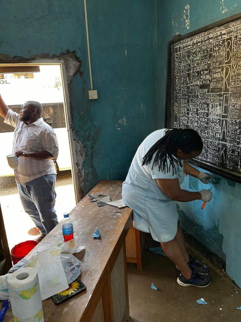 Our team painting a classroom wall